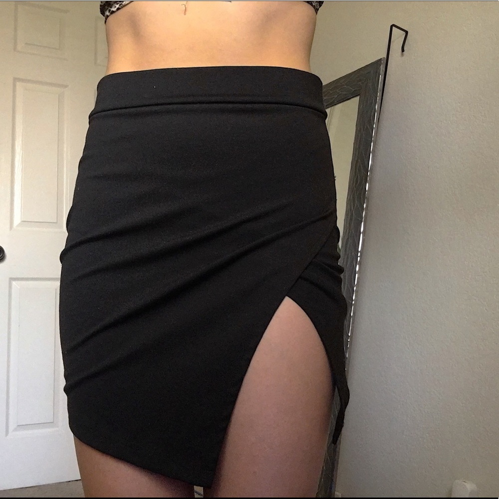 Tight black mini skirt with a slit